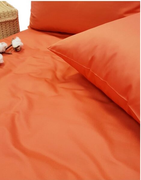 Solid color satin bedsheet in soft terracotta